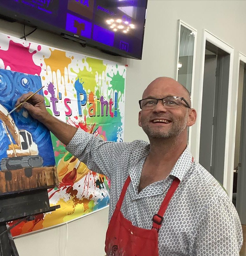 Michael Prichet painting a picture of a construction worker.